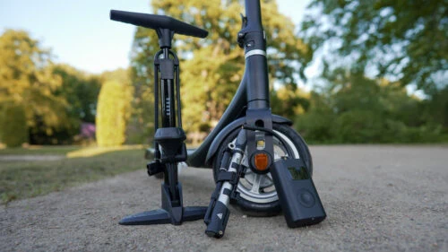 Electric scooter with three different air pumps in front of it