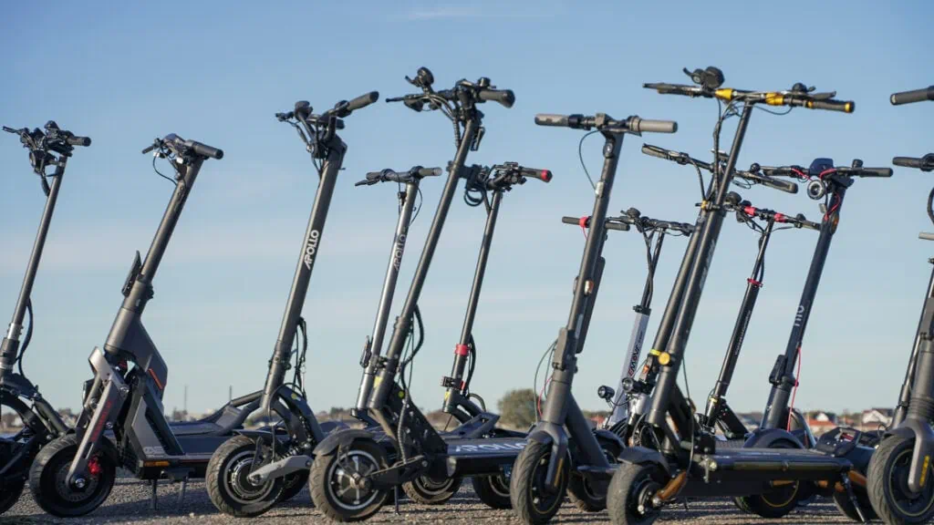 Buying Guide: How To Choose an Electric Scooter 3 Many electric scooters standing next to each other, all owned and tested by ERideHero