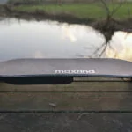 Maxfind Max4 Pro electric skateboard with a landscape background