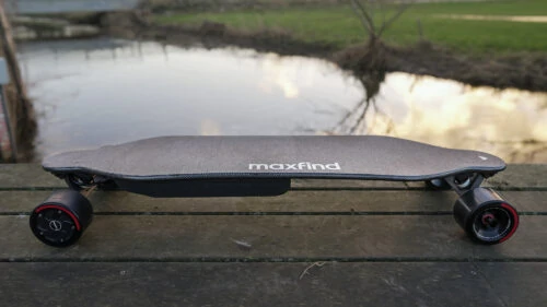 Maxfind Max4 Pro electric skateboard with a landscape background