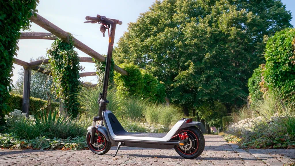 NIU KQi 300X Review: Rides Like a Dream, Built Like a Tank 22 NIU KQi 300X on cobblestone path with green background