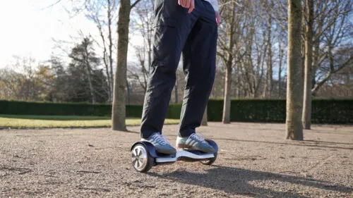 Riding a hoverboard on a gravel trail